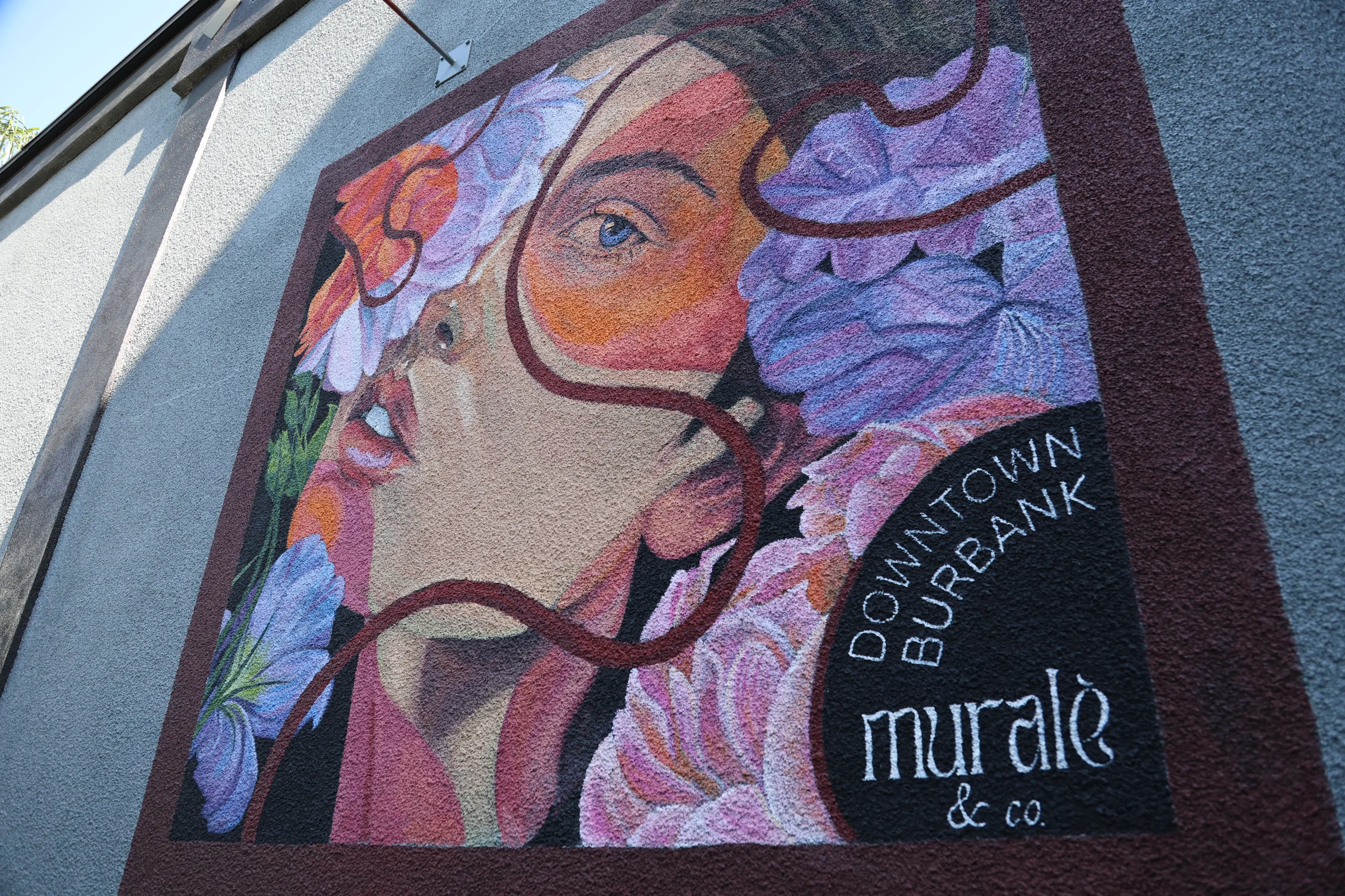 Mural reading Downtown Burbank by Murale and Co. showing a woman among flowers